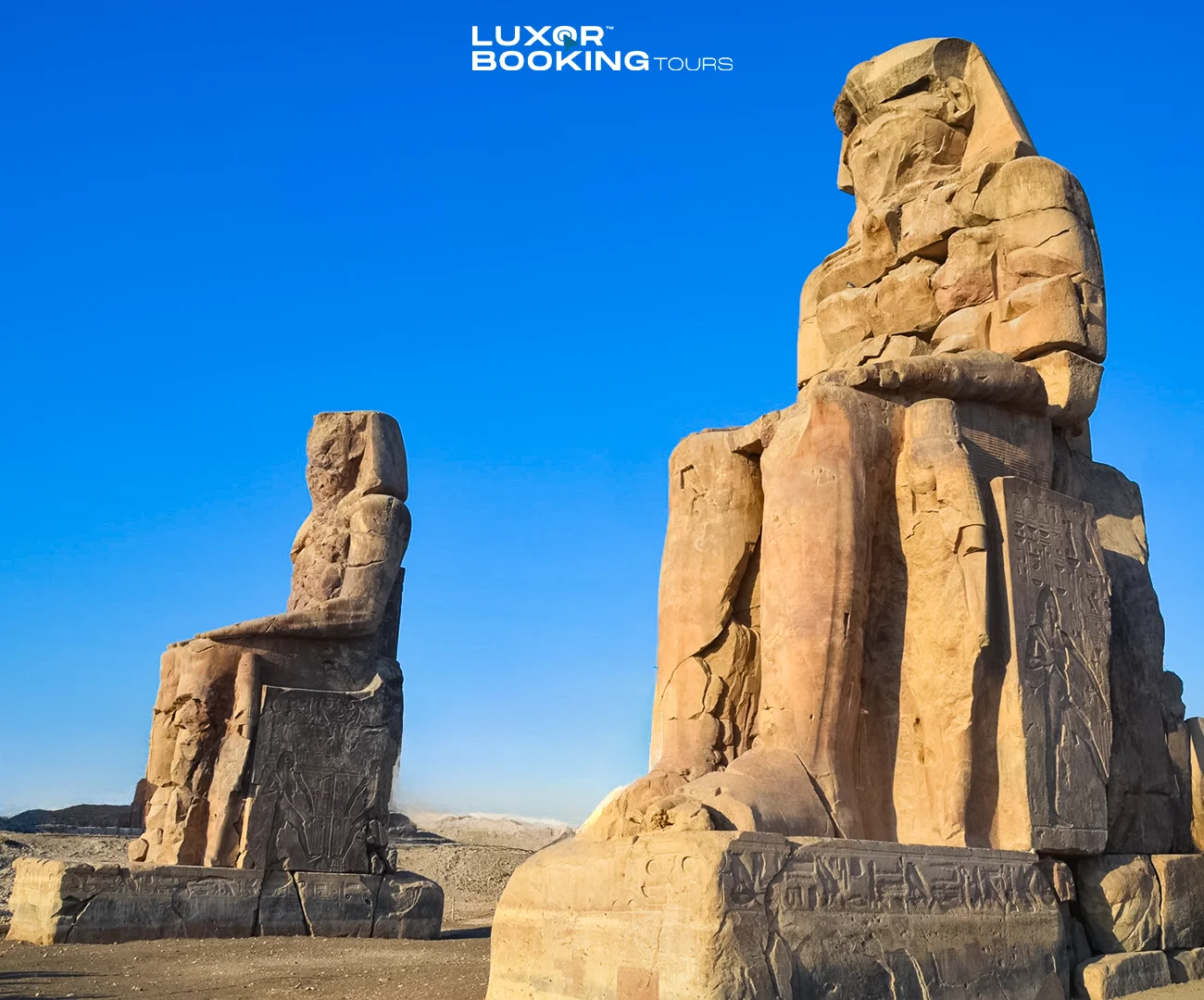Colossi of Memnon statues standing on Luxor’s West Bank