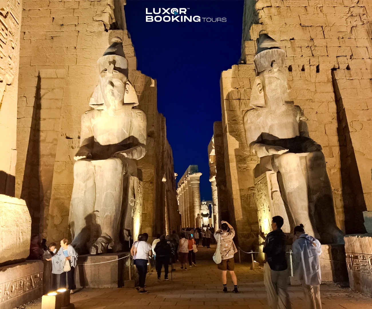 Luxor Temple illuminated at night with calm surroundings