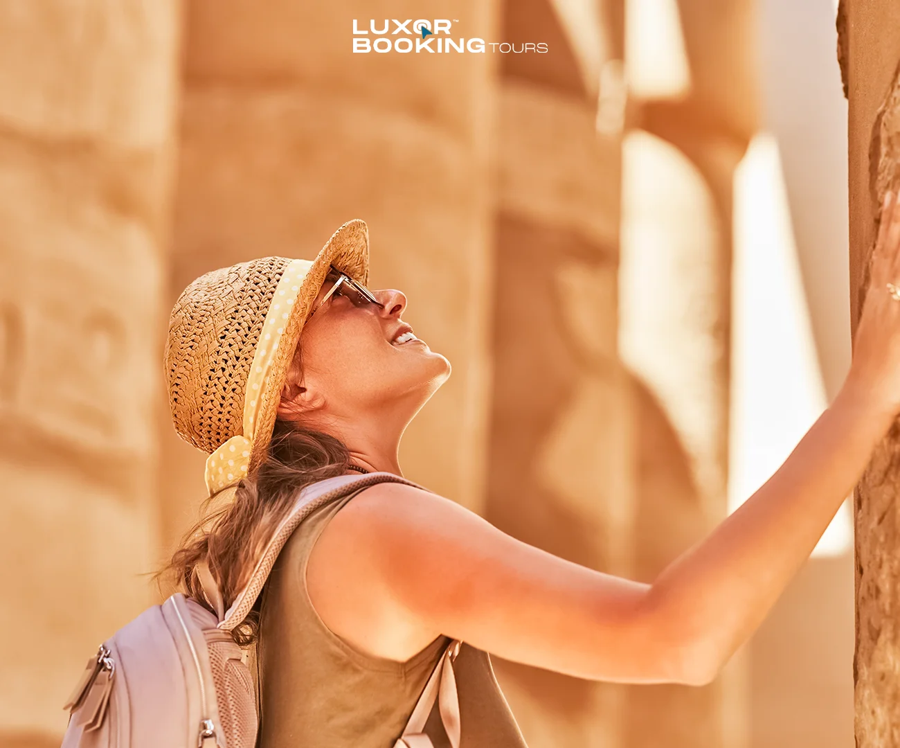 Traveler reviewing a Luxor tour itinerary with temples in the background