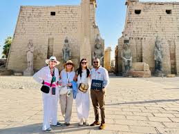 Traveler reviewing travel expenses while overlooking Luxor landmarks