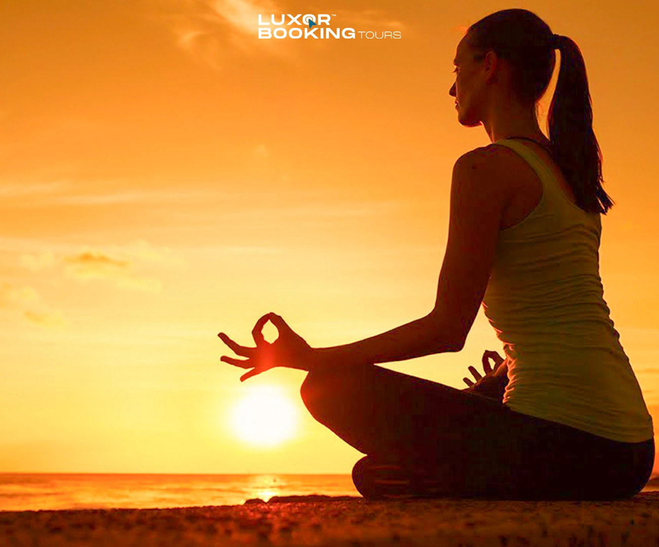 person practicing yoga at sunrise near the nile in luxor
