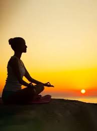 person practicing yoga at sunrise near the nile in luxor