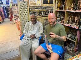 tourist interacting with local vendor in luxor market