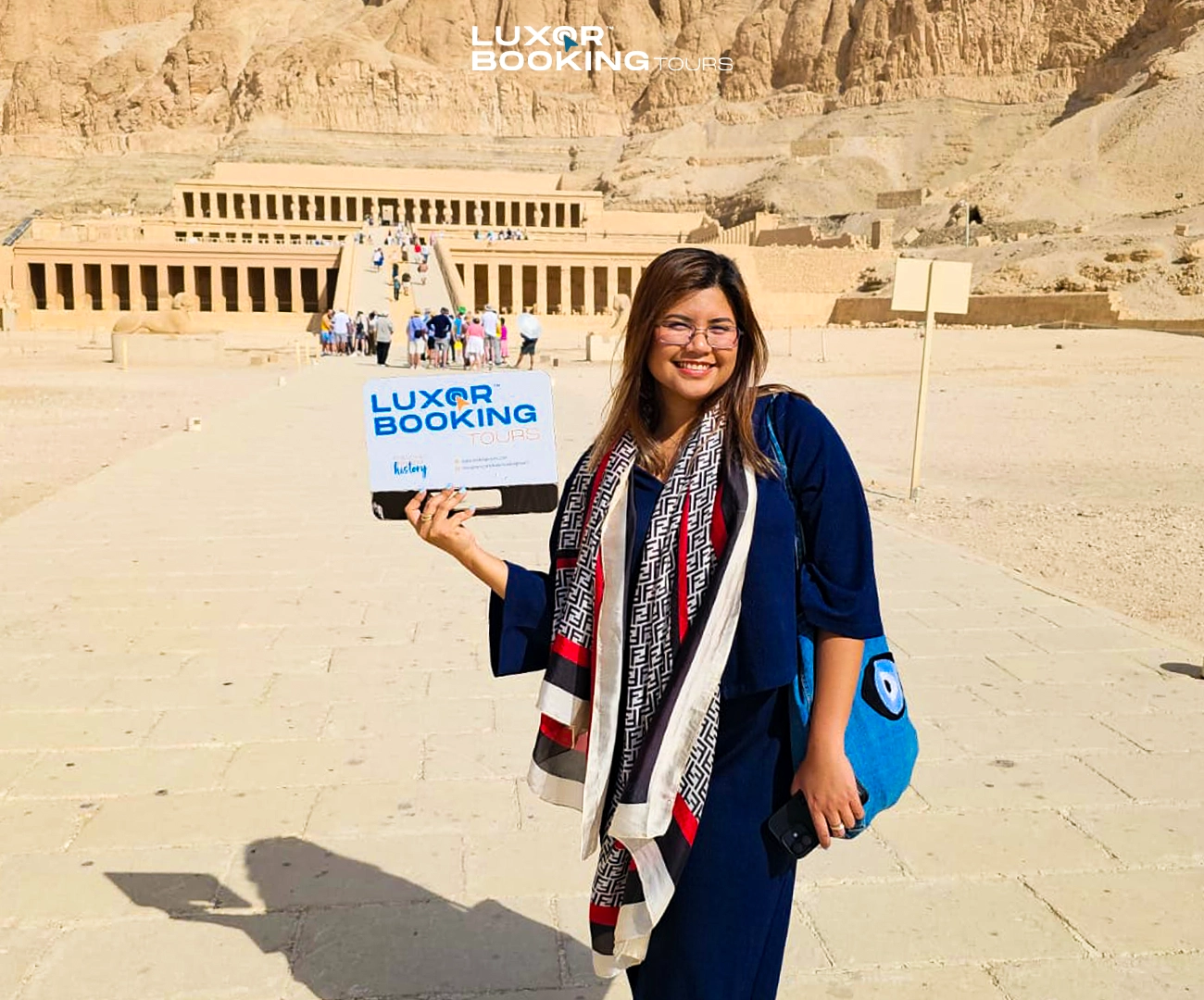 traveler walking through large temple in luxor under sunlight