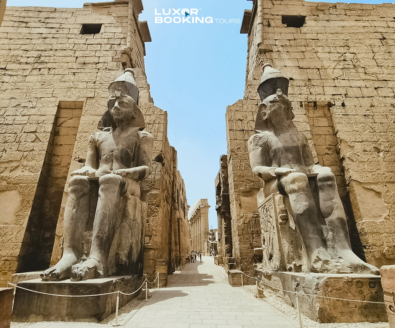 traveler walking through multiple large temple sites in luxor