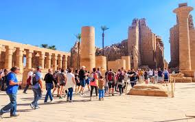 traveler walking through multiple large temple sites in luxor