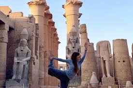 traveler quietly walking through large temple space in luxor